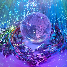 Fibre optic cabling surrounding the globe, symbolic of how fibre optic cabling is becoming a global choice of transmission over coax