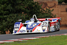 Iconic car with its red, white and blue livery, in front of thousands of spectators at Oulton Park, Cheshire