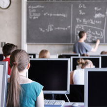 girl looking at blackboard, in class
